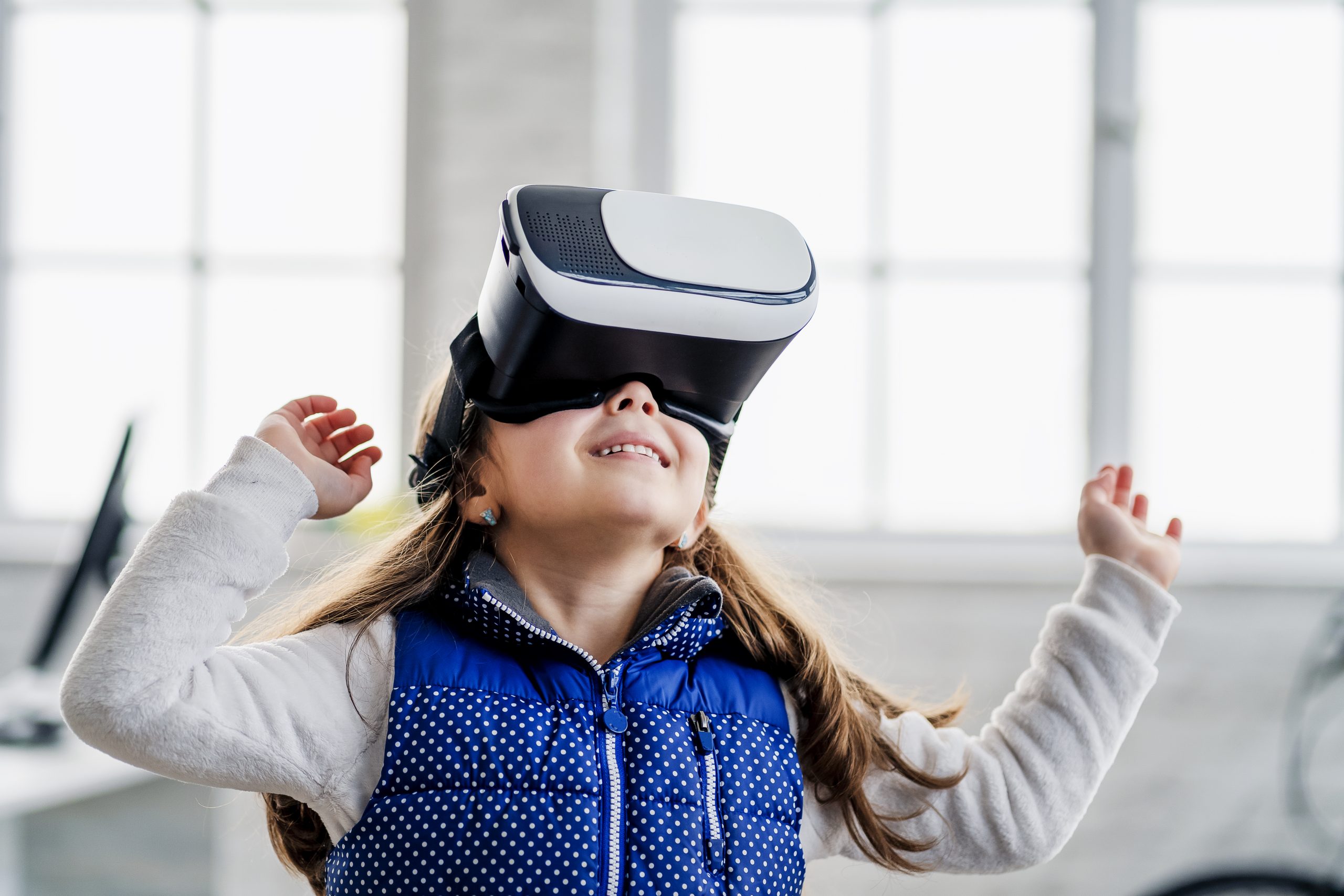 Girl playing with virtual reality headset